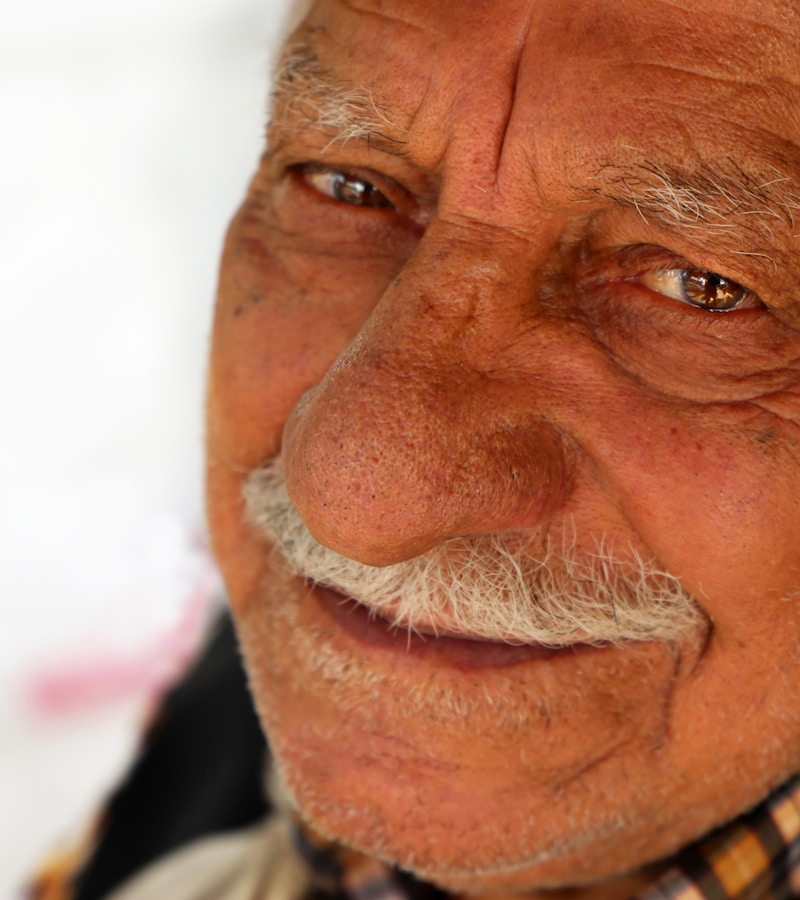 Close-up portrait of a smiling elderly man, warm and confident