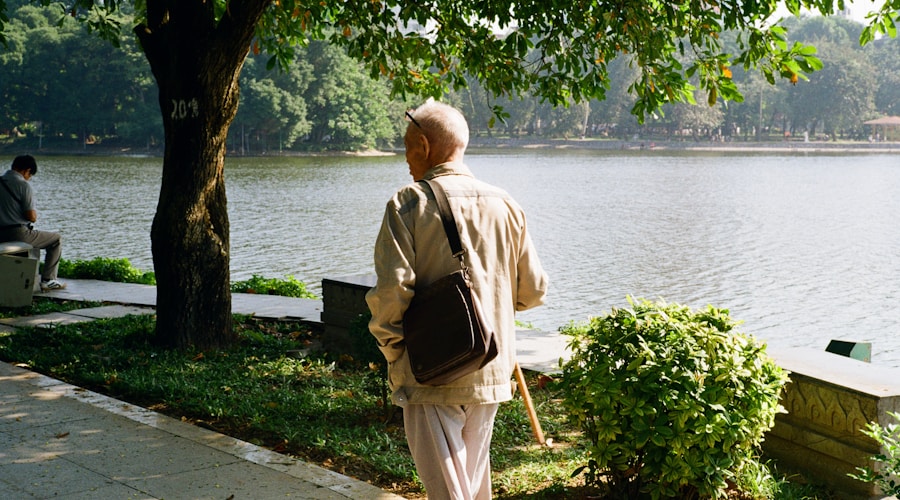 Elderly man walking peacefully by a lake in the park