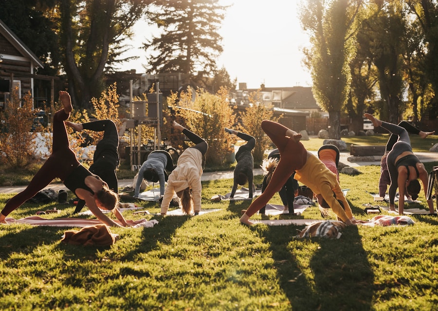 Group of people doing yoga together outdoors in a park